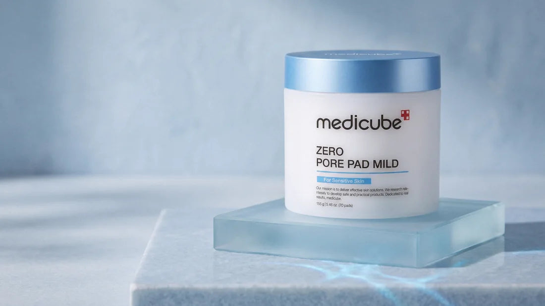 Medicube Zero Pore Pad Mild jar on a block of pale blue frosted glass, in cool morning light